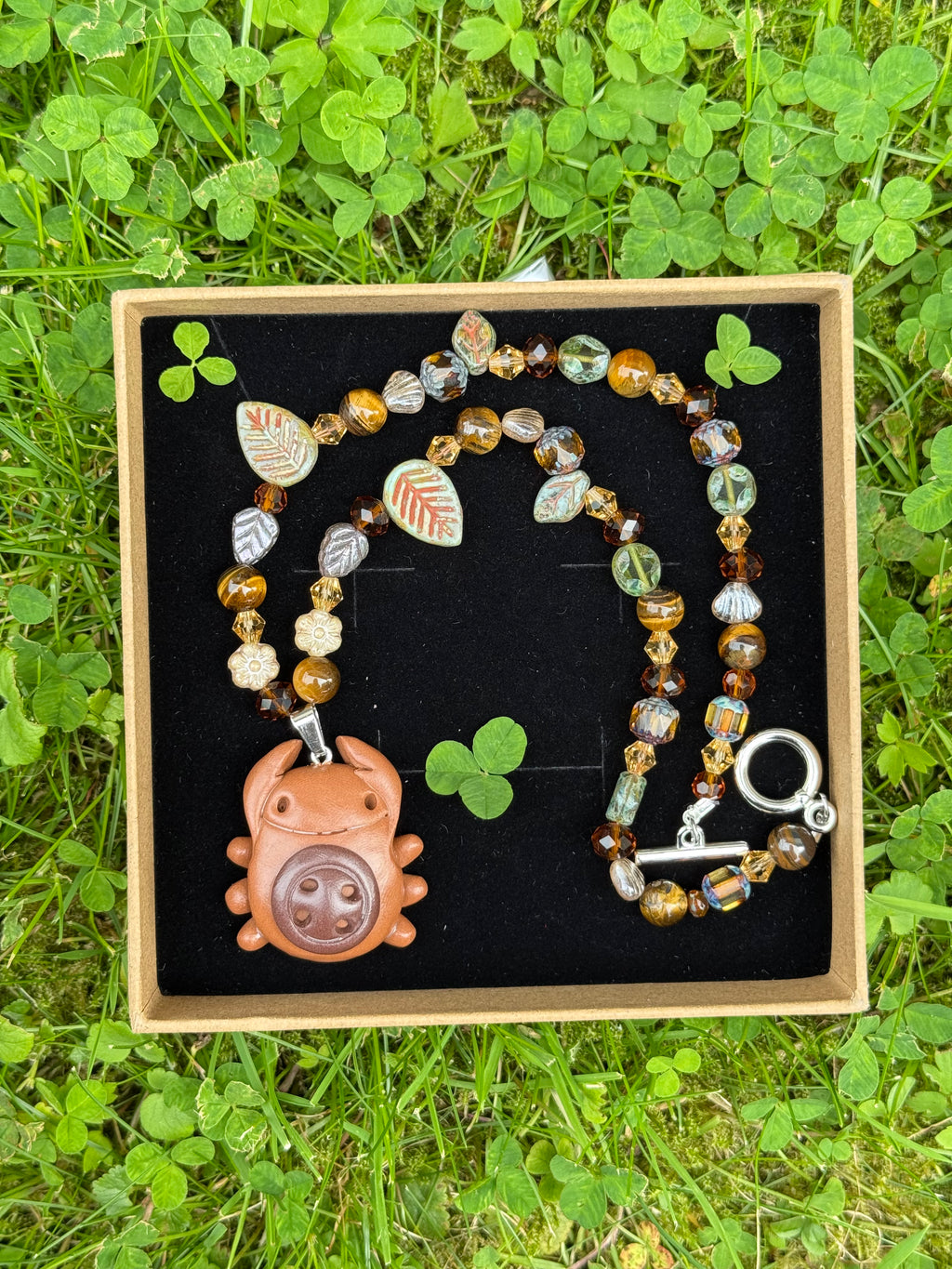 forest button bug necklace