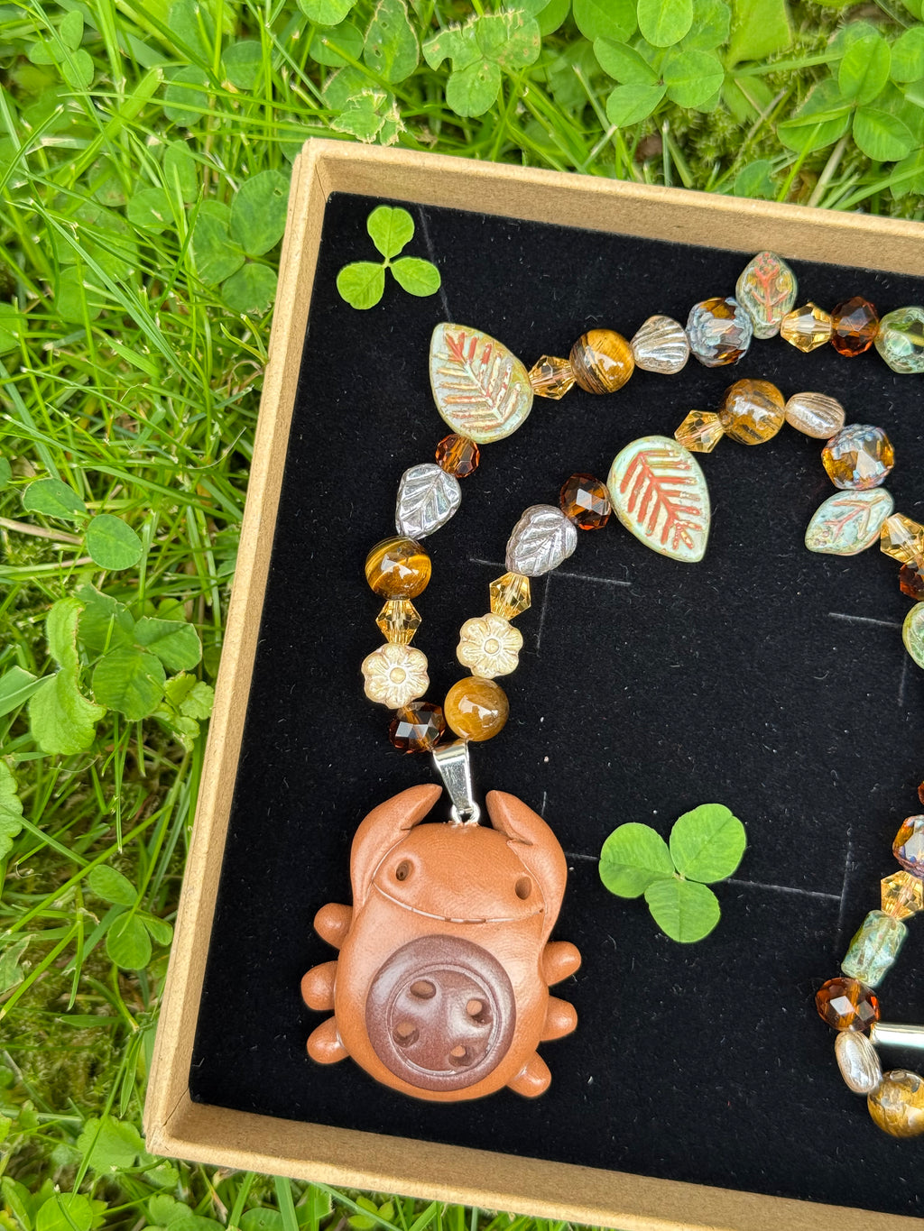 forest button bug necklace