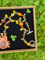 magical forest button bug necklace